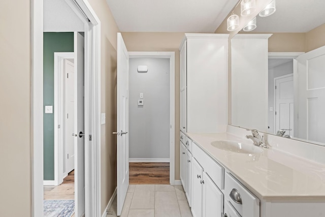 907 7th Ave, Wanamingo, MN 55983 - bathroom with vanity, tile patterned flooring, and baseboards