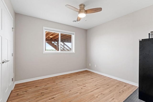 907 7th Ave, Wanamingo, MN 55983 - unfurnished bedroom with light wood finished floors, baseboards, and a ceiling fan