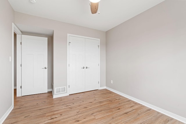 907 7th Ave, Wanamingo, MN 55983 - unfurnished bedroom with light wood-style flooring, baseboards, a closet, and a ceiling fan