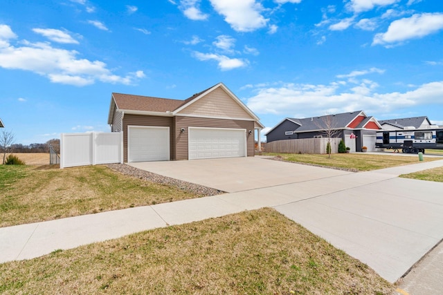 907 7th Ave, Wanamingo, MN 55983 - view of front facade with an attached garage and concrete driveway