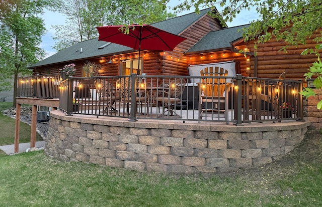 631 Pheasant Run, Winsted, MN 55395 - back of property with log siding, roof with shingles, and a garage