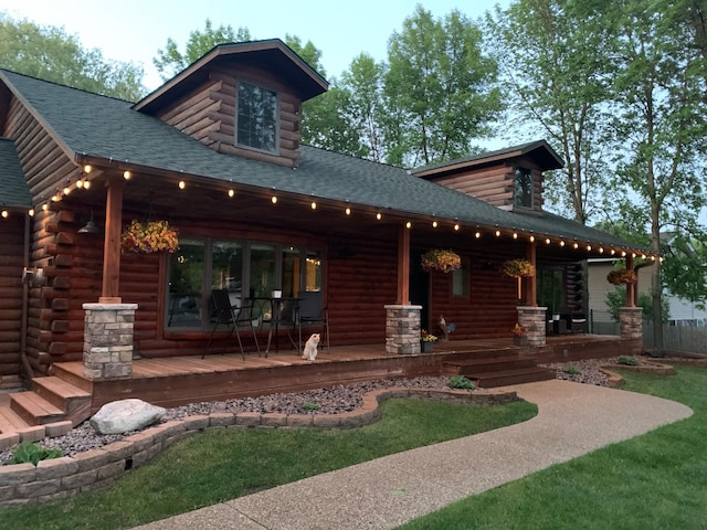 631 Pheasant Run, Winsted, MN 55395 - rear view of house featuring covered porch, roof with shingles, and log exterior