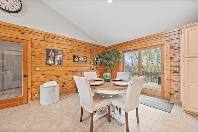 631 Pheasant Run, Winsted, MN 55395 - dining room with lofted ceiling, wooden walls, and light tile patterned floors