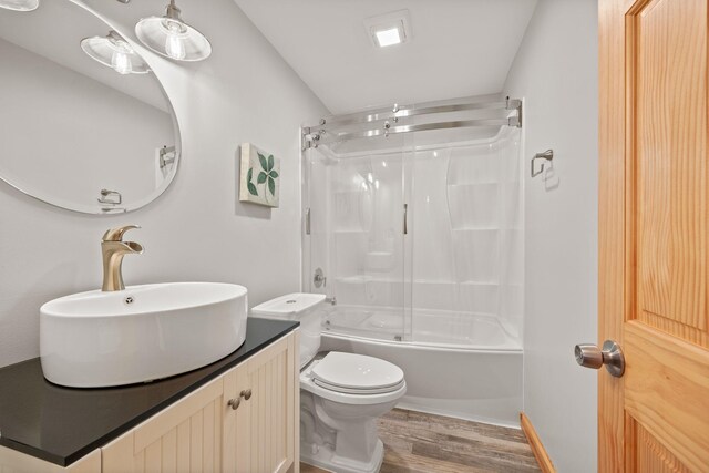 631 Pheasant Run, Winsted, MN 55395 - bathroom with wood finished floors, toilet, shower / bath combination with glass door, and vanity