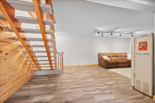 631 Pheasant Run, Winsted, MN 55395 - unfurnished living room with wood finished floors and baseboards