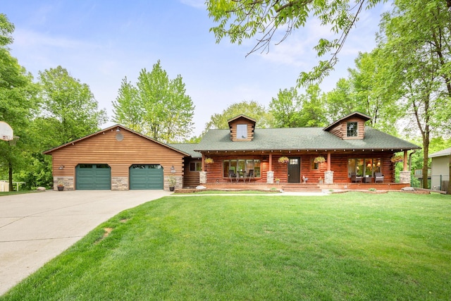 631 Pheasant Run, Winsted, MN 55395 - cabin featuring an attached garage, concrete driveway, a front yard, covered porch, and a shingled roof