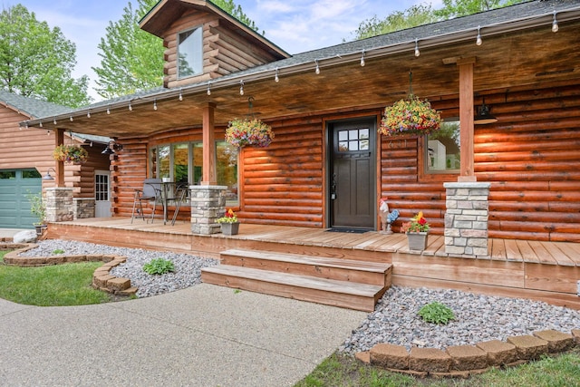 631 Pheasant Run, Winsted, MN 55395 - entrance to property with covered porch, log exterior, and a shingled roof