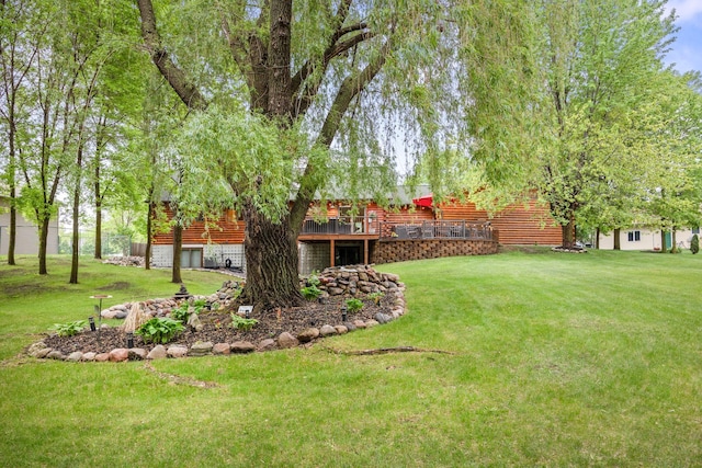 631 Pheasant Run, Winsted, MN 55395 - view of green lawn featuring a wooden deck and an attached garage