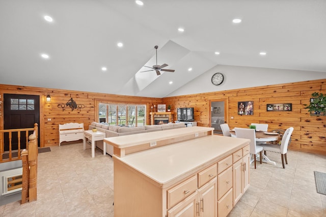 631 Pheasant Run, Winsted, MN 55395 - kitchen with wood walls, a kitchen island, high vaulted ceiling, ceiling fan, and light tile patterned floors