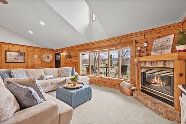 631 Pheasant Run, Winsted, MN 55395 - carpeted living area featuring wooden walls, lofted ceiling, a fireplace, and recessed lighting
