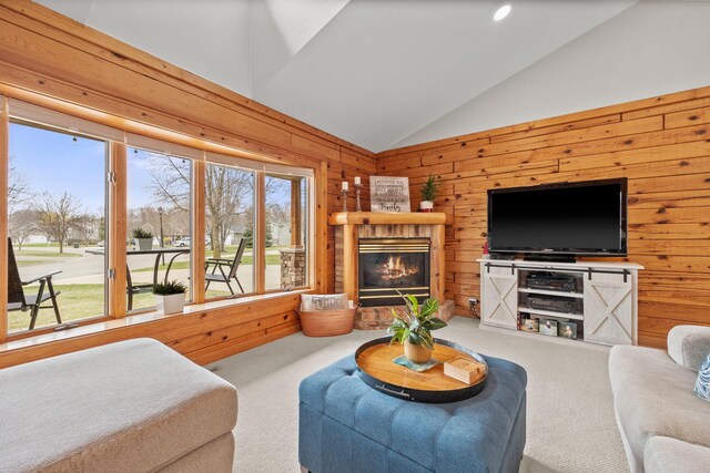 631 Pheasant Run, Winsted, MN 55395 - carpeted living area with wooden walls, lofted ceiling, and a glass covered fireplace
