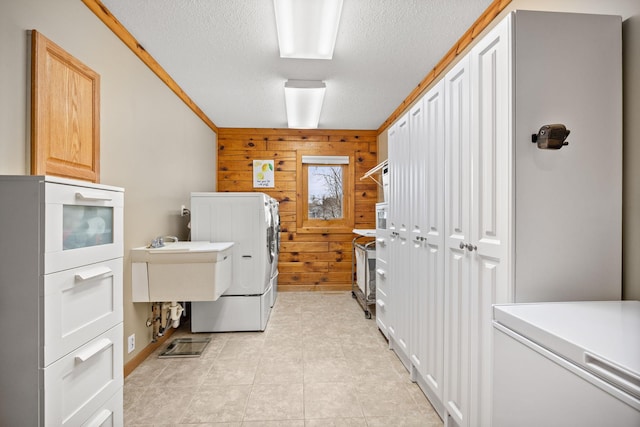 631 Pheasant Run, Winsted, MN 55395 - laundry room with washer and dryer, wooden walls, a textured ceiling, cabinet space, and light tile patterned floors