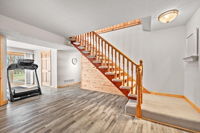 631 Pheasant Run, Winsted, MN 55395 - workout area featuring wood finished floors and baseboards