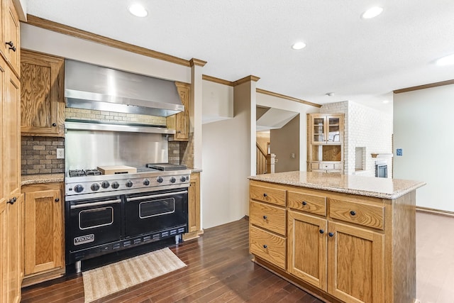 5411 Southwood Dr, Bloomington, MN 55437 - kitchen with wall chimney range hood, backsplash, double oven range, crown molding, and dark wood finished floors