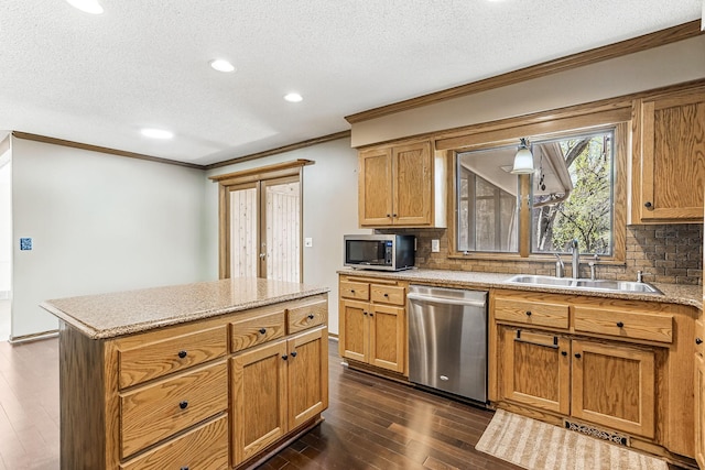 5411 Southwood Dr, Bloomington, MN 55437 - kitchen with a textured ceiling, crown molding, appliances with stainless steel finishes, a sink, and dark wood-style floors
