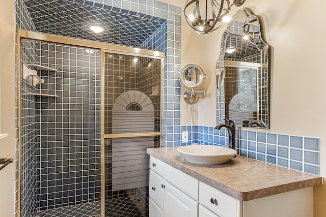 5411 Southwood Dr, Bloomington, MN 55437 - bathroom featuring vanity, a chandelier, tasteful backsplash, and a shower stall