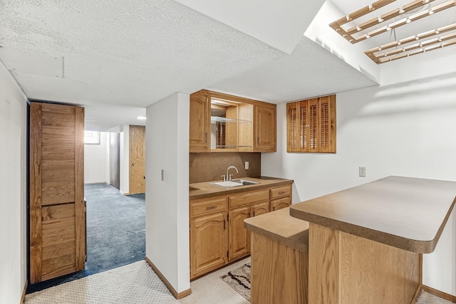 5411 Southwood Dr, Bloomington, MN 55437 - kitchen featuring a sink, baseboards, light carpet, and a peninsula
