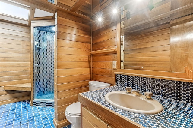 5411 Southwood Dr, Bloomington, MN 55437 - full bathroom with wooden walls, tile patterned flooring, vanity, toilet, and tiled shower