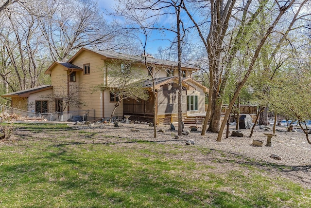 5411 Southwood Dr, Bloomington, MN 55437 - rear view of property with fence, a lawn, and a sunroom