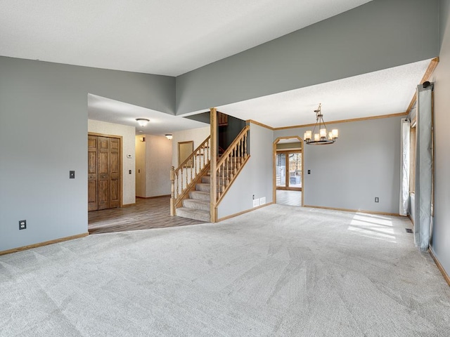 empty room featuring baseboards, carpet, stairs, and a notable chandelier
