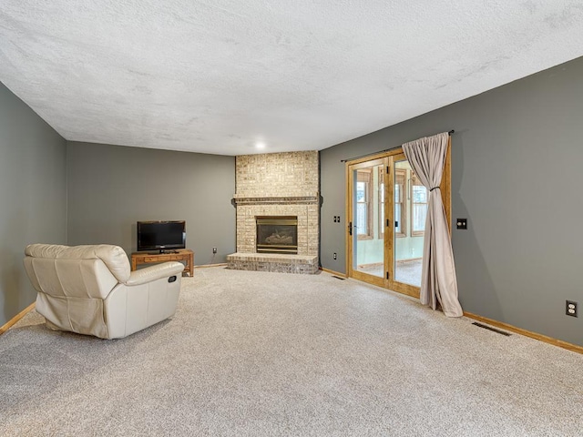 living area with carpet floors, a textured ceiling, and baseboards