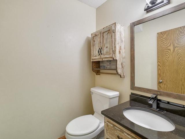 half bath featuring toilet and vanity