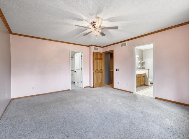 unfurnished bedroom featuring light carpet, crown molding, and visible vents