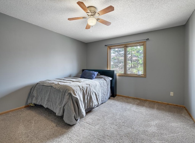 bedroom with carpet floors, a textured ceiling, and baseboards