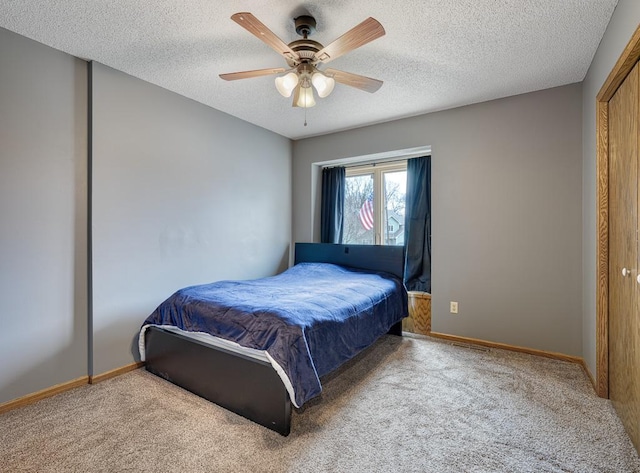 bedroom with carpet floors, a textured ceiling, and baseboards