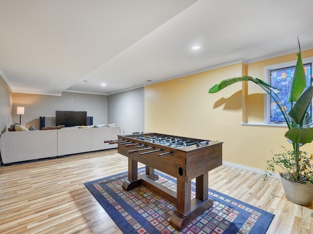 game room with baseboards, wood finished floors, recessed lighting, and ornamental molding