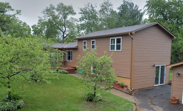 895 334th Ave NE, Cambridge, MN 55008 - view of side of property with a yard, a shingled roof, a wooden deck, a patio, and view of scattered trees