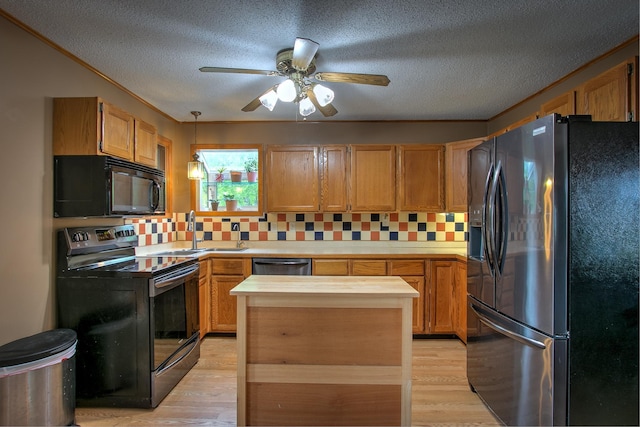 895 334th Ave NE, Cambridge, MN 55008 - kitchen featuring black appliances, light wood-style floors, tasteful backsplash, a ceiling fan, and a sink