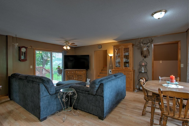 895 334th Ave NE, Cambridge, MN 55008 - living room with light wood-style floors, ceiling fan, and stairway