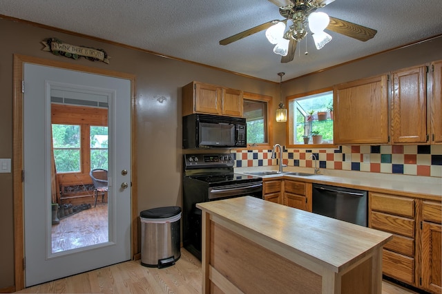 895 334th Ave NE, Cambridge, MN 55008 - kitchen with black microwave, dishwashing machine, butcher block countertops, a sink, and light wood-style floors