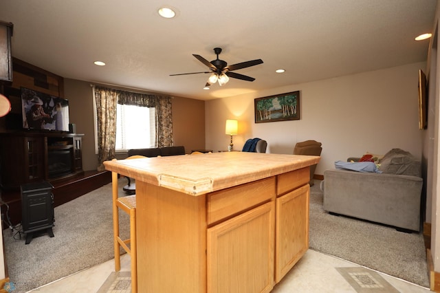 kitchen featuring recessed lighting, ceiling fan, open floor plan, and light carpet