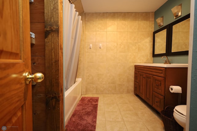 bathroom with shower / bath combination with curtain, tile patterned flooring, vanity, and toilet
