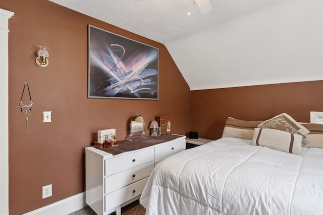 bedroom featuring baseboards, a ceiling fan, and vaulted ceiling