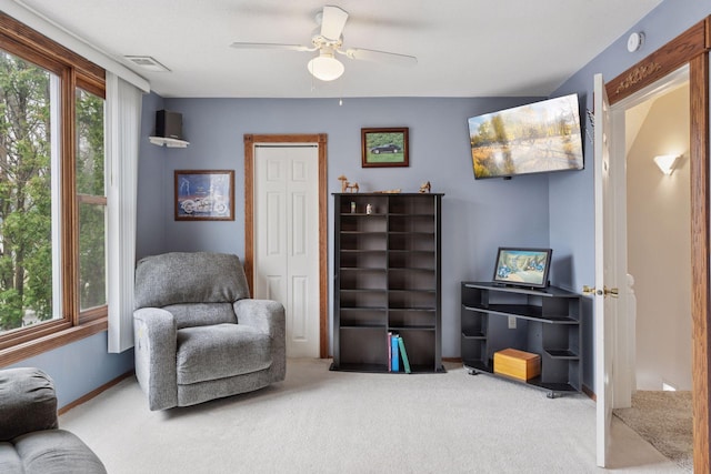 sitting room featuring carpet floors, ceiling fan, baseboards, and visible vents