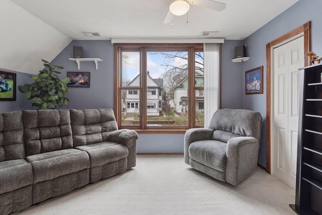 carpeted living area with baseboards, ceiling fan, lofted ceiling, and visible vents