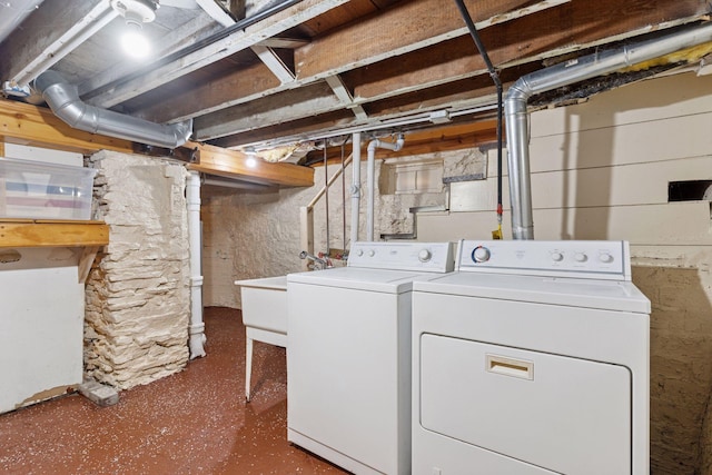 washroom featuring washer and dryer, laundry area, and a sink