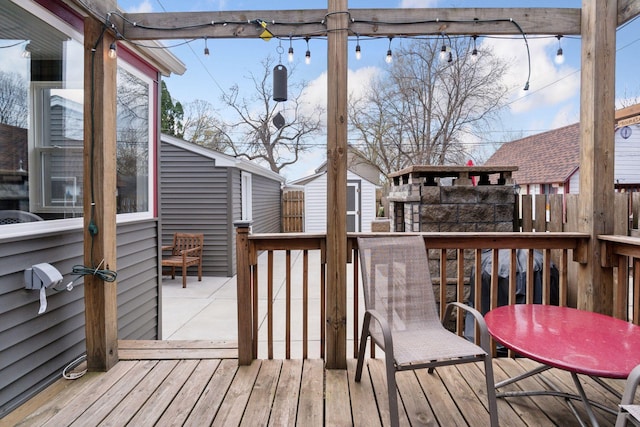 wooden deck featuring an outdoor structure and a shed