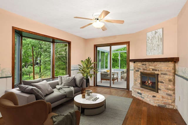 5410 Creek View Ln, Edina, MN 55439 - living room featuring hardwood / wood-style floors, ceiling fan, a brick fireplace, and a textured ceiling