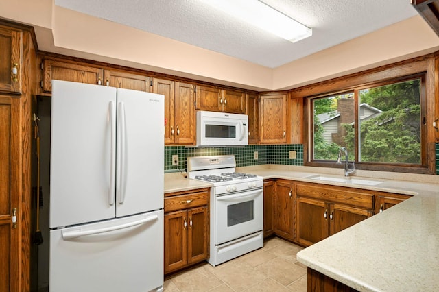 5410 Creek View Ln, Edina, MN 55439 - kitchen with white appliances, a sink, brown cabinetry, backsplash, and a textured ceiling