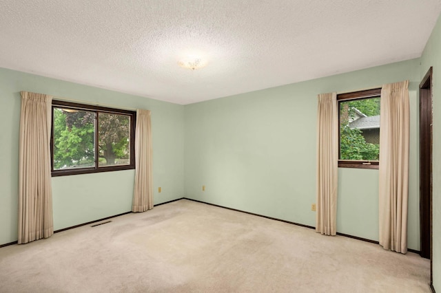 5410 Creek View Ln, Edina, MN 55439 - unfurnished room with light colored carpet, a textured ceiling, and baseboards