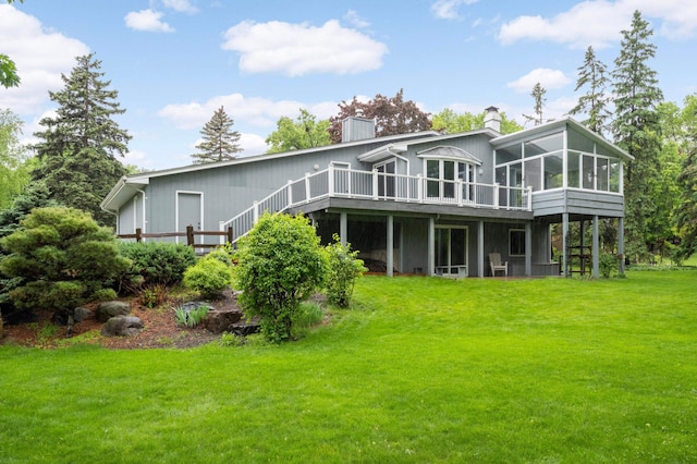 5410 Creek View Ln, Edina, MN 55439 - back of house with a sunroom, a chimney, a wooden deck, a lawn, and stairway