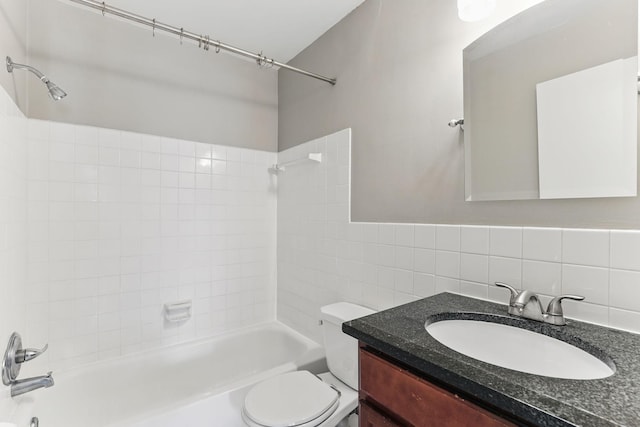 full bath featuring tasteful backsplash, vanity, tile walls, toilet, and shower / bathtub combination