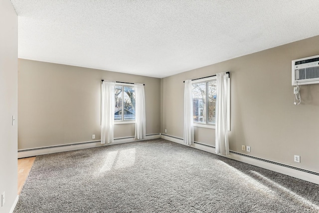 unfurnished room with carpet floors, a textured ceiling, and a wall unit AC