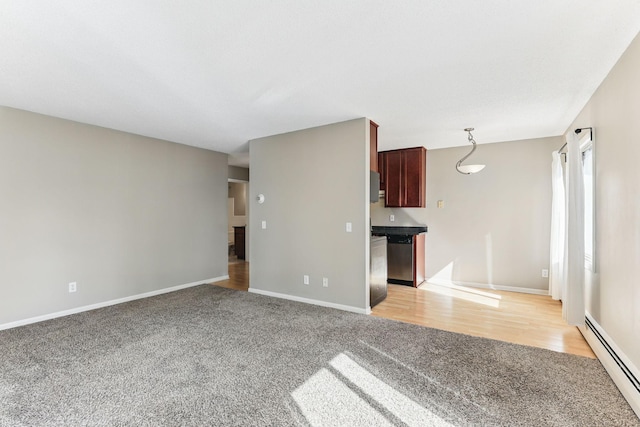 unfurnished living room featuring baseboards, light colored carpet, and baseboard heating