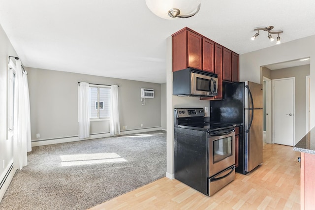 kitchen featuring a baseboard radiator, an AC wall unit, dark brown cabinets, stainless steel appliances, and light wood-style flooring