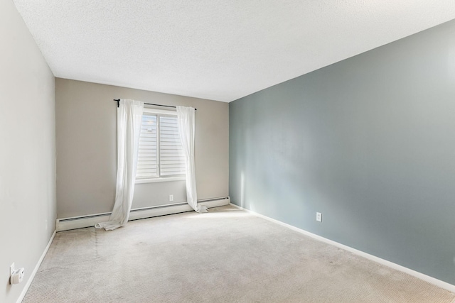 unfurnished room with baseboards, carpet flooring, and a textured ceiling